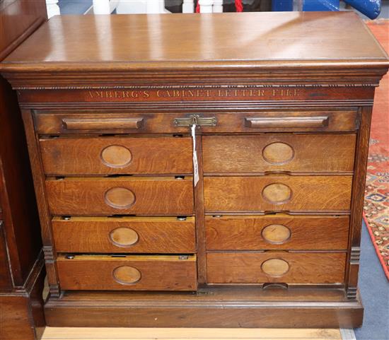 An oak tambour stationery cabinet marked Ambergs Cabinet Letter File W.78cm